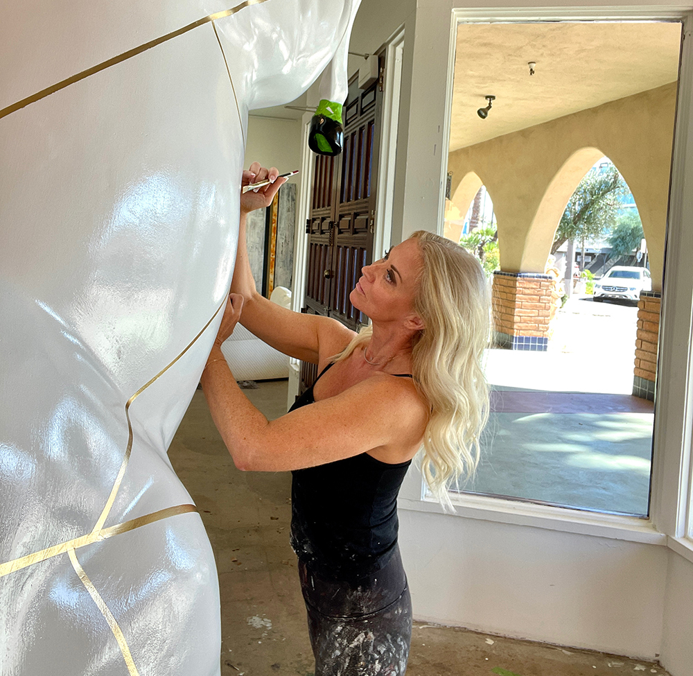 Niki Woehler painting a large white horse for art installation